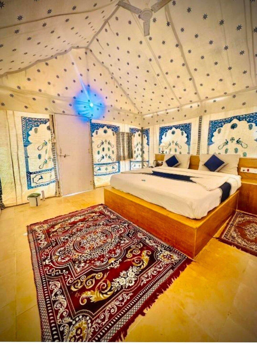 Candlelight dinner setup on dunes under stars — RUDVO Jaisalmer